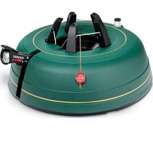 A green round object with a black handle and a red button.