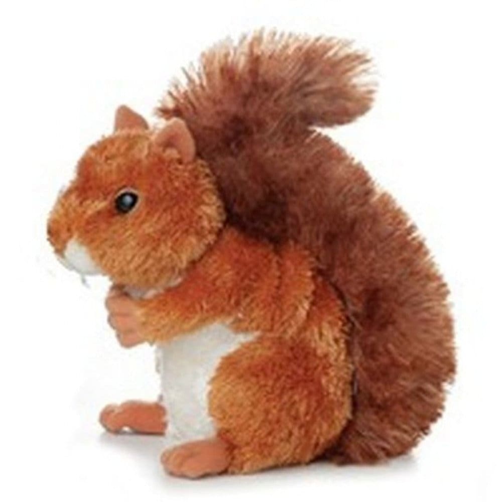 A stuffed squirrel is sitting on the ground.