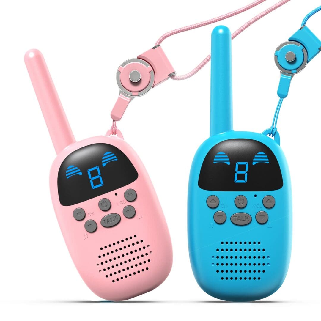 Two pink and blue walkie talkies with headphones hanging from the side.