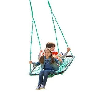 A boy and girl on a swing set.